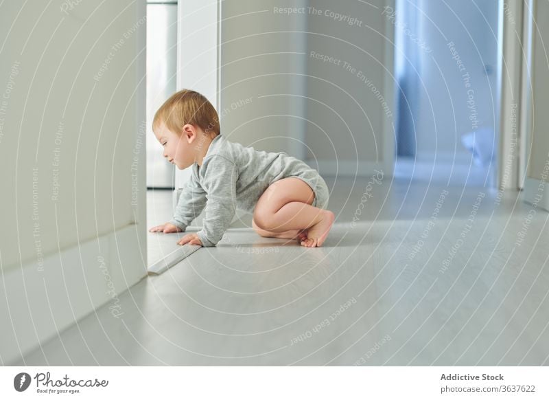 Happy baby crawling on floor happy cute smile home toddler child childhood cheerful kid joy lifestyle sweet development explore experience glad play excited