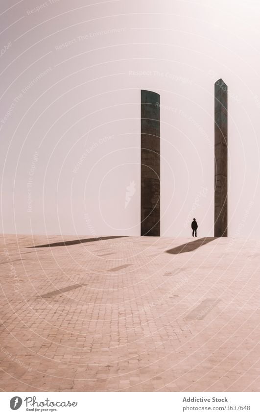 Person between columns near Champalimaud Foundation building champalimaud foundation landmark square person spacious architecture facade stone lisbon portugal