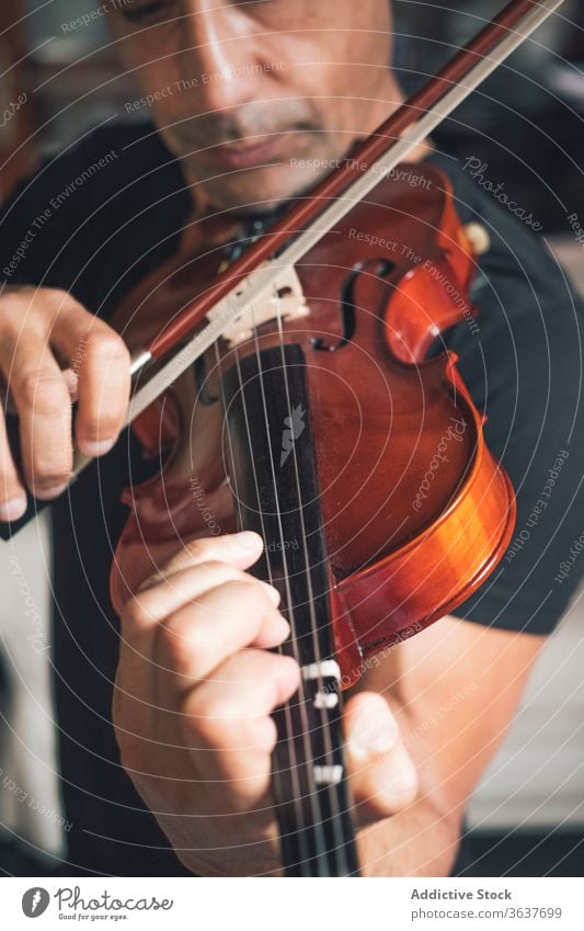 Anonymous male musician playing violin instrument man talent sheet violinist melody ethnic hispanic perform rehearsal sound entertain tune hobby rhythm player