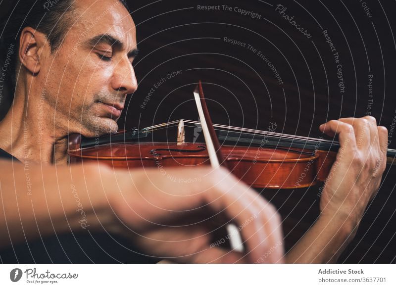 Ethnic male musician playing violin instrument man talent sheet violinist melody ethnic hispanic perform rehearsal sound entertain tune hobby rhythm player