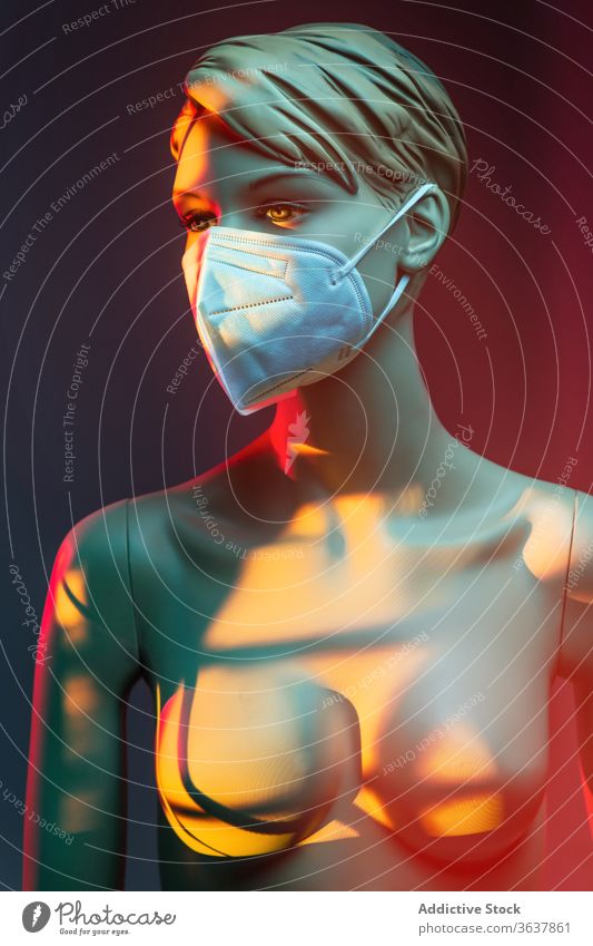 Naked dummy in protective mask in studio mannequin woman coronavirus concept naked medical female plastic illuminate light colorful vivid vibrant multicolored