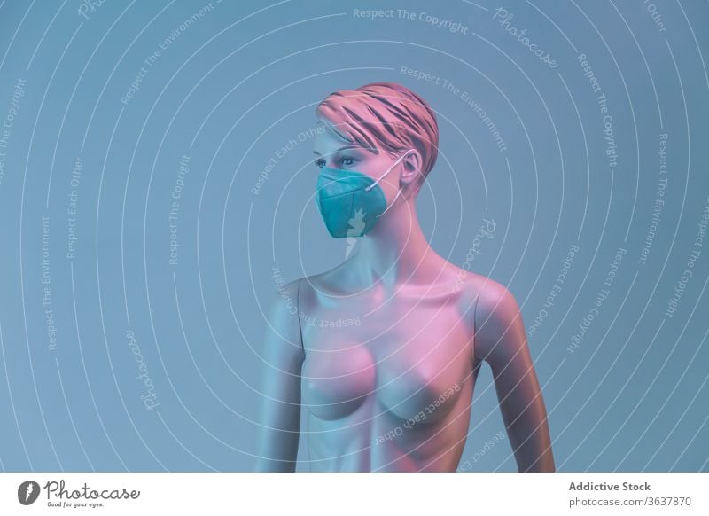 Naked dummy in protective mask in studio mannequin woman coronavirus concept naked medical female plastic illuminate light colorful vivid vibrant multicolored