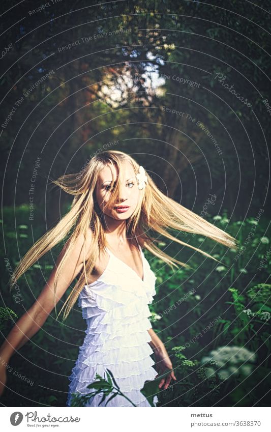 Lady in white dress dancing in the woods with her hair fly in the air forest fairy joyful princess windswept lady nature beautiful young woman girl dancing