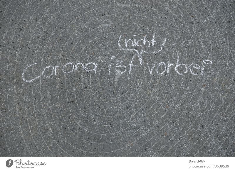 Corona is not over - words written with chalk on the street corona Street authored leap coronavirus Corona virus pandemic Virus Risk of infection Illness COVID