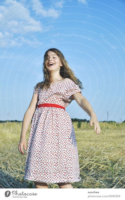 happy girl in retro summer dress on a straw chopper Light heartedness Summery Feminine Cornfield young girl Grain Child Field acre Summer dress Action Infancy