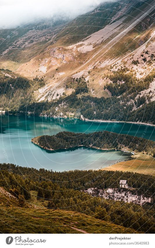 View from Piz Corvatsch in the Engadin in Graubünden in Switzerland to the Silsersee Sunbeam Day Light Exterior shot Alps Nature Nature reserve Effort