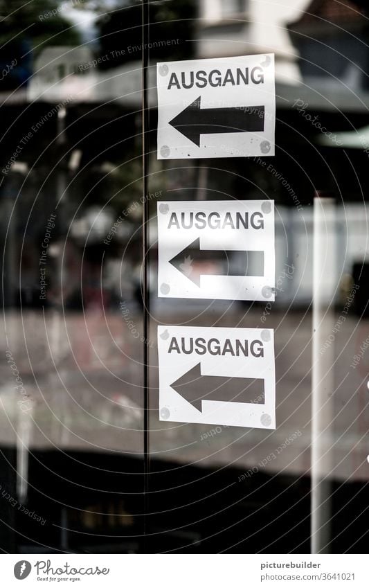 three exit signs Way out door Pane Glass door Reflection Arrow Black White Colour photo Sign Direction Signs and labeling Signage Deserted Clue Orientation