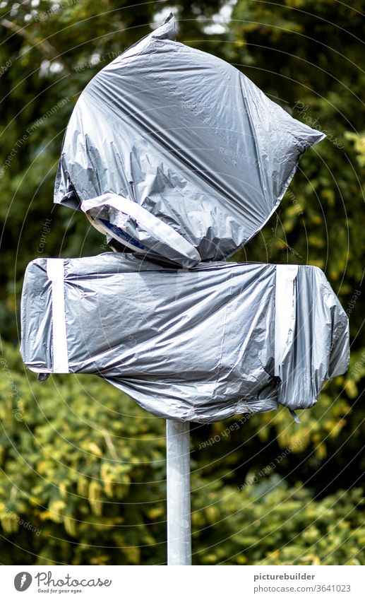 Packed road signs tarpaulin Signs Signs and labeling stake Packaged shrouded Round Rectangle Adhesive tape Invisible Gray green Day Deserted Exterior shot