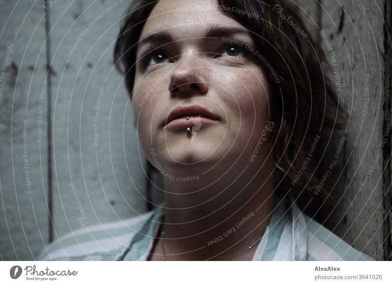 Portrait of a young woman in front of a wooden wall freckly luck Joy stripe pattern Blouse Model Emotions emotionally sensuality Exceptional Freckles Jewellery