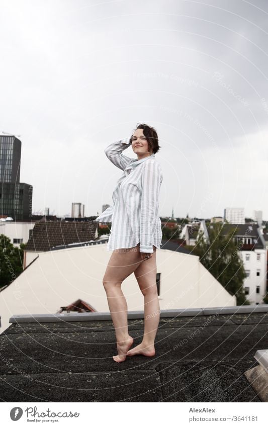 Portrait of a young, barefoot woman on a roof Young woman Top windy hair brunette already Intensive Youth (Young adults) 18-25 years Showing one's bellybutton