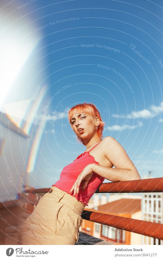 Woman standing on street woman millennial pink hair different female summer railing city grimacing lean freedom triumph urban delight lady happy style