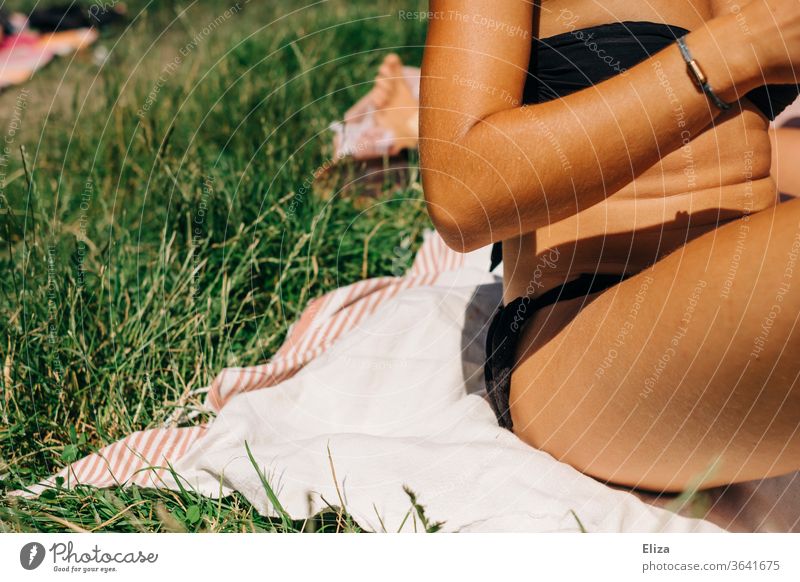 Young woman in bikini on a blanket in the meadow in the sunshine. sunbathe Bikini bathing weather Woman Summer Nature Meadow Blanket Sit Relaxation Sun Summery