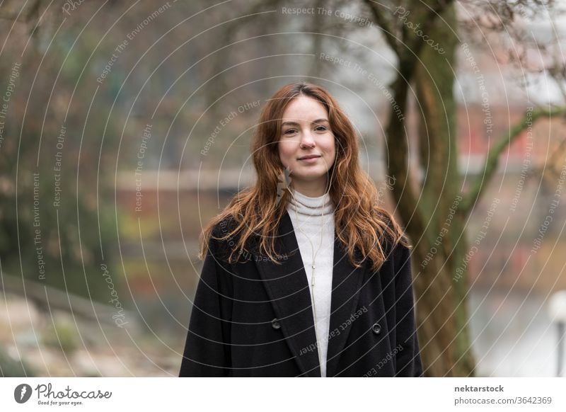 Portrait of Twenty Year Old Caucasian Woman in Park caucasian ethnicity woman female earphones audio music listening brown hair real life model real person