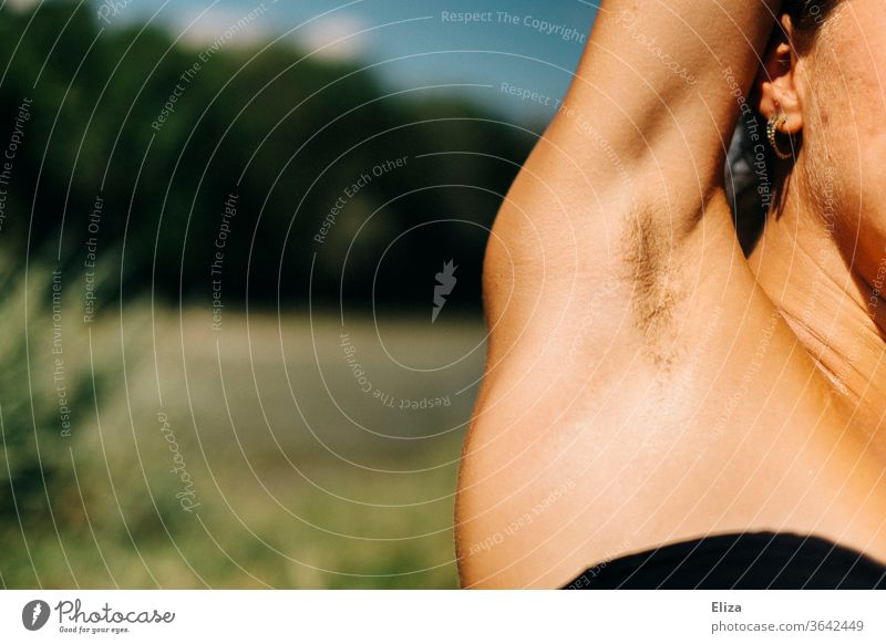 Woman raises her arm and you can see her armpit hair Underarm hair Hair Armpit Unshaven Feminism beauty ideal natural Emancipation body hair Summer Bikini out