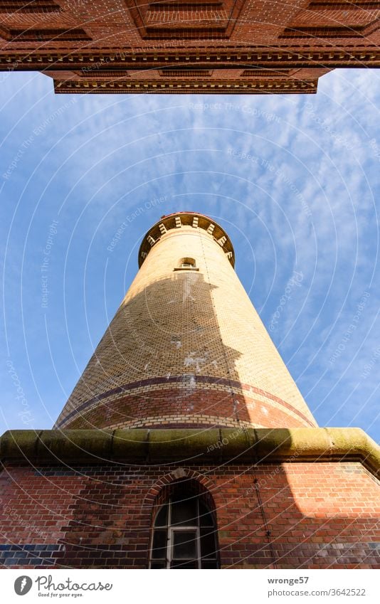 Arrival | View between the two lighthouses at Cape Arkona up into the blue light cloudy sky, the smaller of the two casting its shadow on the larger tower