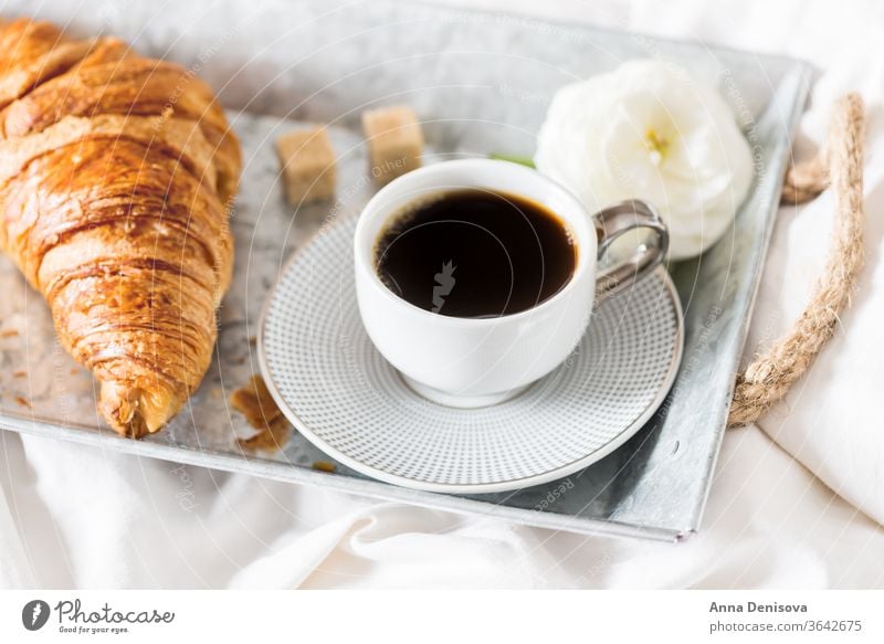 Fresh Croissant, Cup of Coffee and Ranunculus Flowers. Breakfast coffee croissant breakfast in bed morning romance pastry cup white table ranunculus flowers