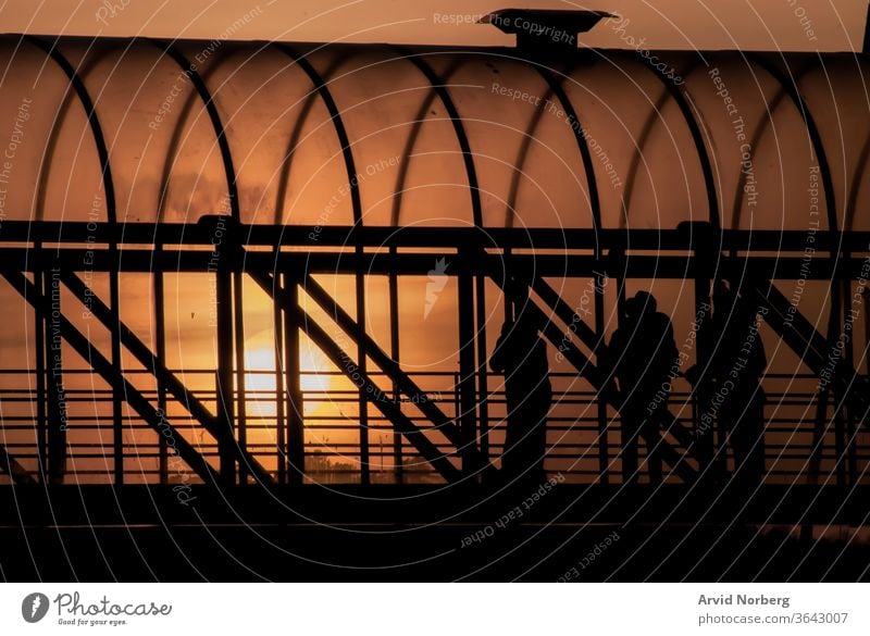 Several people in a walkway bridge during orange sunset background beautiful beauty boardwalk evening glass idyllic landscape morning nature outdoor paradise