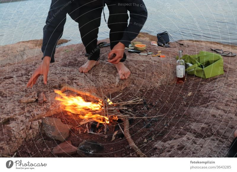 Fire by the lake campfire outdoor Boy (child) Man time-out Fireplace Flame Hot Burn Wood Blaze Wilderness Ignite Glow Adventure chill To enjoy Happy Nature