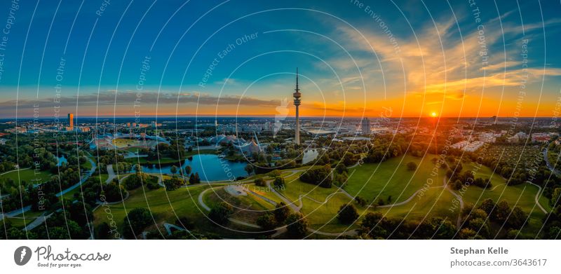 Eyecatching sunrise view over Munich at a wonderful morning at a summer day as panorama. Muenchen park aerial atmosphere authentic image photo green total