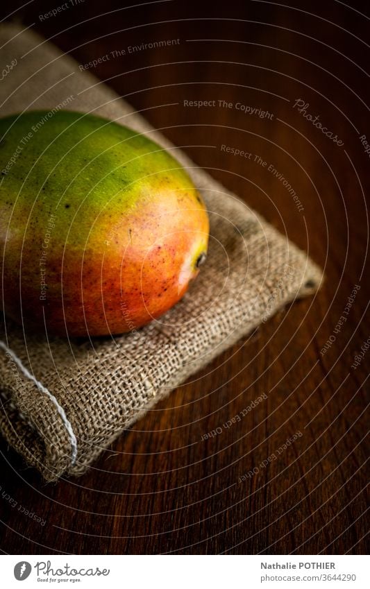 Mango on burlap mango mango fruit Colour photo Wooden table Light Fruit Tropical fruits juce jucy juicy fruits Food Healthy Eating Fresh Nutrition