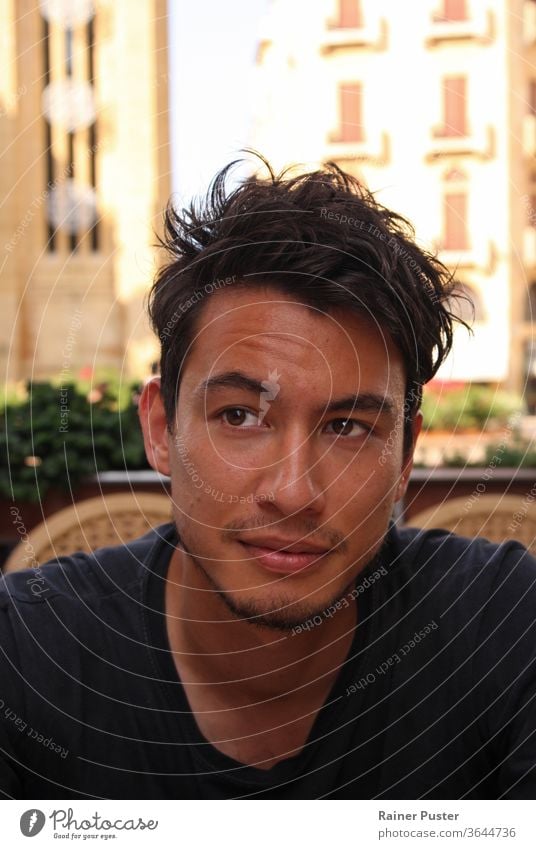 Young man with wild dark hair in a cafe in Beirut, Lebanon attractive beirut casual close-up eurasia eurasian eurasian man face guy handsome lebanese lebanon