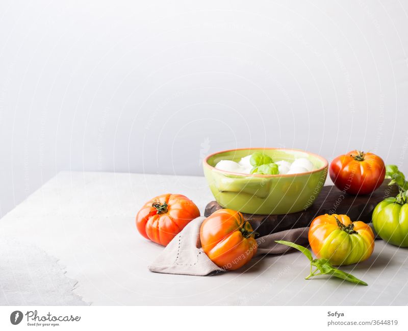 Italian food tomato mozzarella still life italian cuisine cheese cook uncooked caprese salad pasta spaghetti sauce local gray rustic wooden board eat gourmet