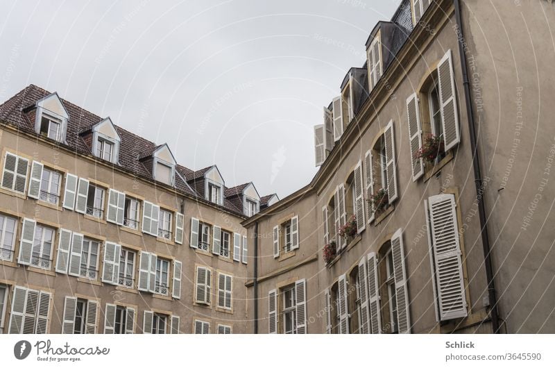 House front in Metz Lorraine houses Facades metz France Window Dormers folding shutter Roof Sky Gray Covered angles Old