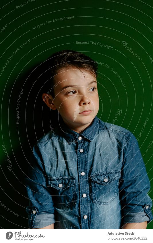 Schoolboy looking away posing in colorful wall confident cool achieve unemotional friendly style lifestyle kid preteen portrait show optimist schoolboy adorable