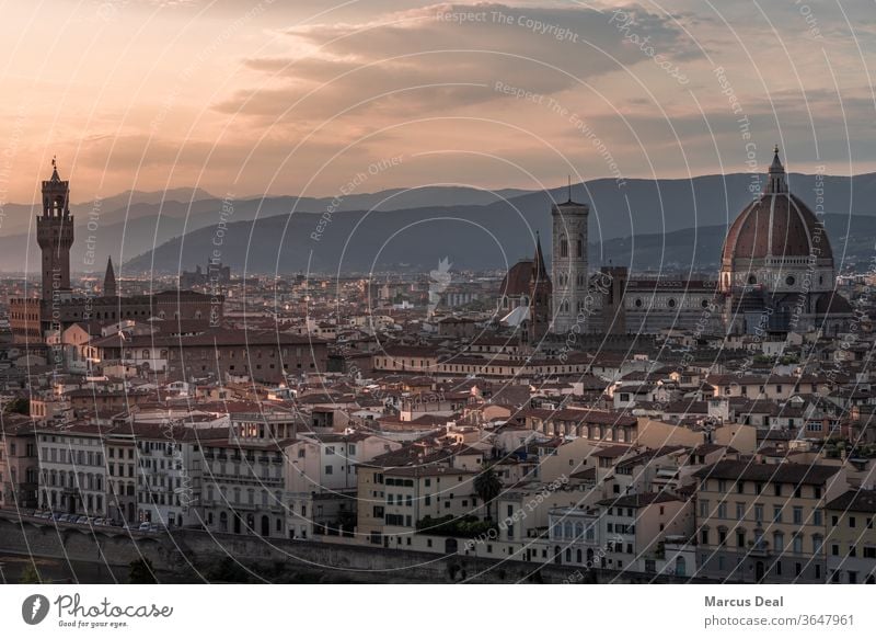 Florence skyline at sunset with Duomo and towers with mountains in background florence italy city duomo florence duomo cityscape tuscany valley orange