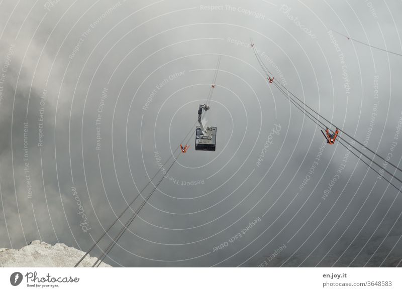 Cable car rides through fog and low hanging clouds Gondola gondola ropes Fog Clouds mountains Ambiguous voyage Tourism Mountain Alps Deserted depth