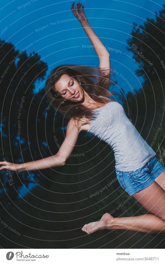 Girl is dancing ecstatically in the dark, 90s soap-box style film photo imitation girl jumping ecstatic ballet joyful lady young woman female happy