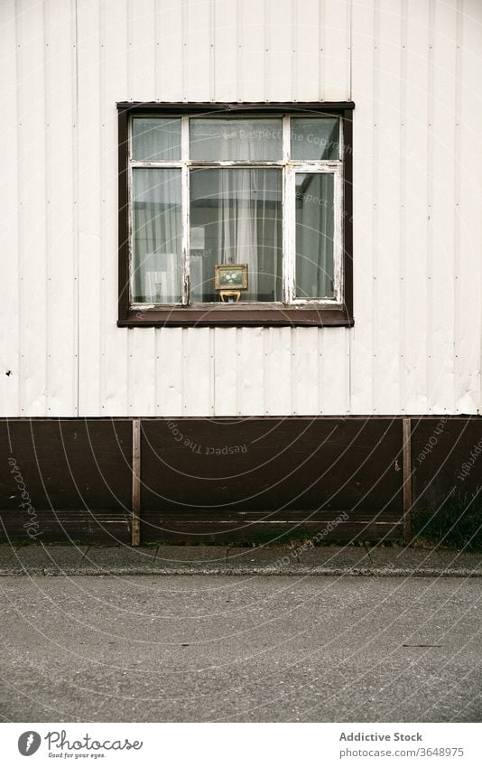 Exterior of house with shabby window old building residential facade exterior siding weathered wall wooden aged cottage daytime grunge construction structure