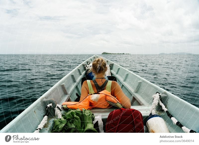 Traveling woman on boat in sea traveler wanderlust float vacation calm summer female vessel water tranquil relax trip weekend adventure serene idyllic peaceful