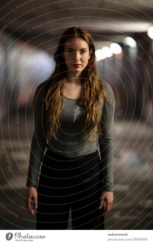 Three Quarter Length Portrait of Young Woman Standing in an Underpass portrait female one person girl confident young woman underpass selective focus