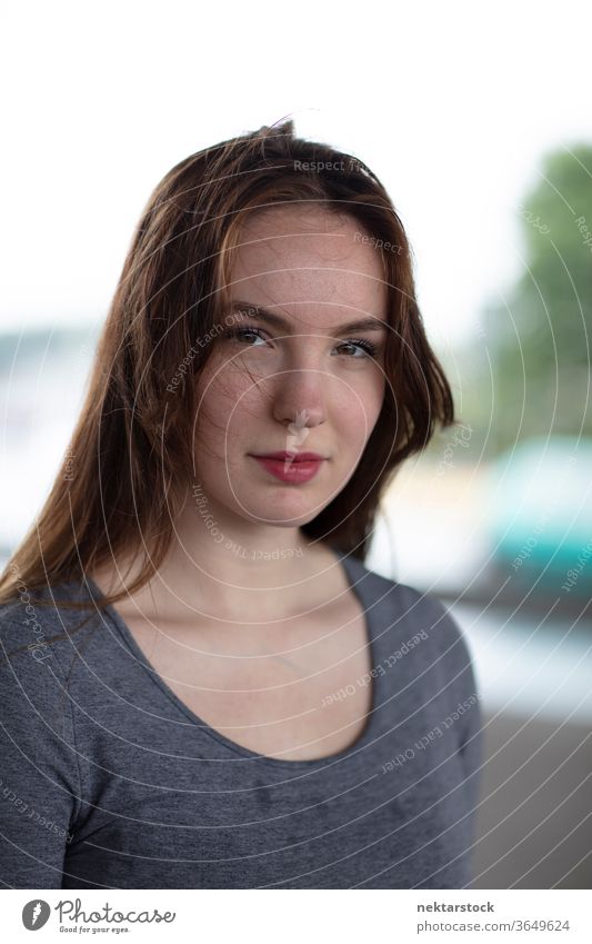 Portrait of a Pretty Woman Standing Outdoors Smirking female one person girl young woman confidence smirk headshot female face facial expression