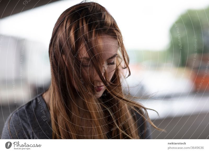 Portrait of Sad Young Woman Looking Down female one person girl sad young woman portrait human emotion depressed unhappy looking down head shot close up