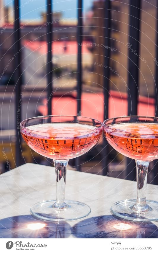 Two crystal stemmed glasses with rose wine white marble party pink drink dinner table luxury light background modern alcohol bar beautiful celebration concept