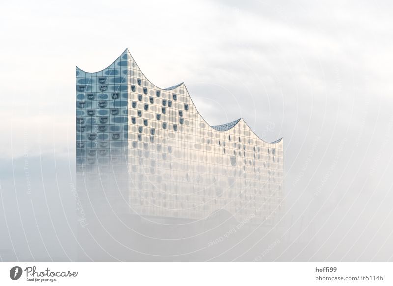 the Elbphilharmonie slowly emerges from the morning mist Elbe Philharmonic Hall Fog Shroud of fog Landmark Hamburg Architecture built Exceptional Facade Culture