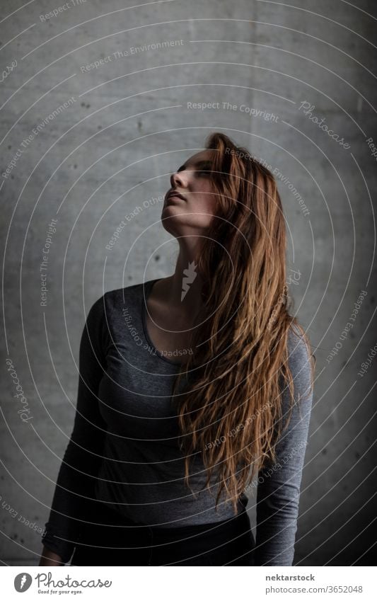 Young Woman with Chin Raised Looking Upwards female one person girl hairstyle portrait young woman looking up head raised caucasian ethnicity youth culture