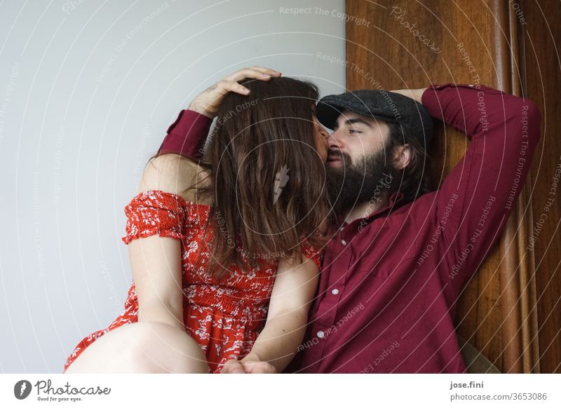 Young couple sitting close together, looking into each other's eyes and kissing. boyfriend girlfriend Touch hugging Comfortable side view Love Couple