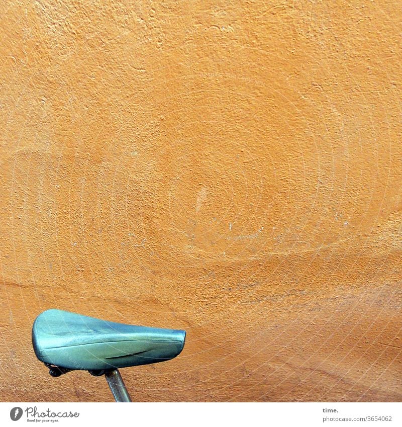 urban mobile future Bicycle saddle Wall (building) Wall (barrier) Old Trashy Plaster Orange Yellow cyan Saddle Seat shine