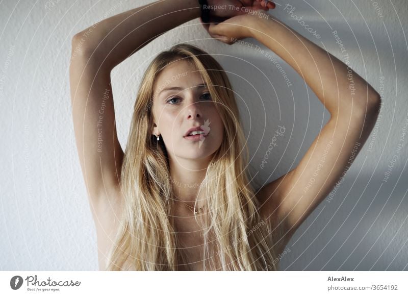 Portrait of a beautiful, young, blonde woman in front of a white wall portrait Woman Young woman Blonde already Slim Long-haired Esthetic Model Identity