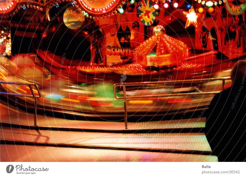 everything turns Fairs & Carnivals Speed Red Long exposure Theme-park rides Evening Light Motion blur Rotate Section of image Swing Spirited Centrifugal force