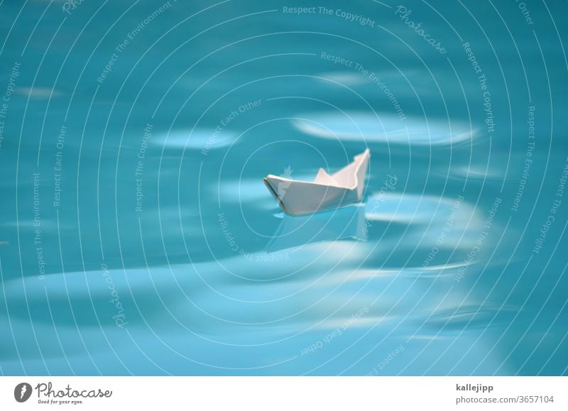 symbolbid paper ship in water Paper boat Water voyage Traveling Waves Small Orientation Navigation Sailing Sailing ship peril explorers Columbus ocean Blur