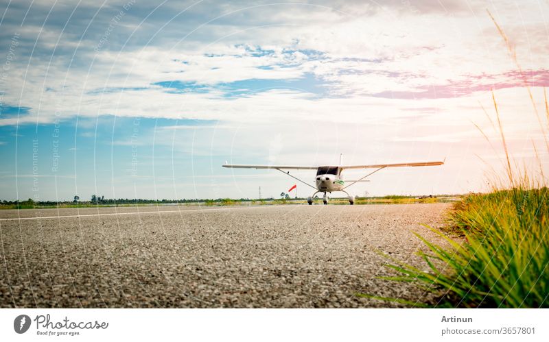 Small airplane coming  on a taxiway in the morning with beautiful blue sky. Bright life. High growth and high risk business concept. outdoor wings fly wheels