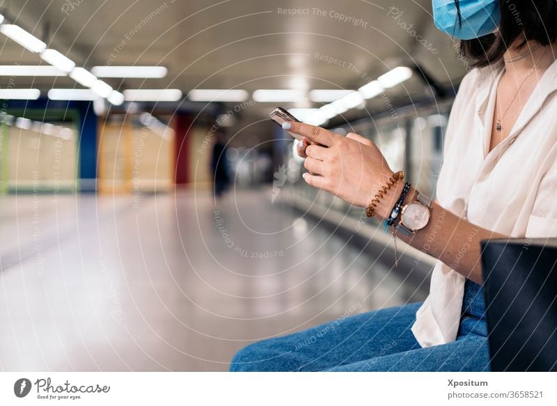 Side view of a close up of an unrecognizable woman using her smartphone alone attractive beautiful beauty cellphone city communication commute device female