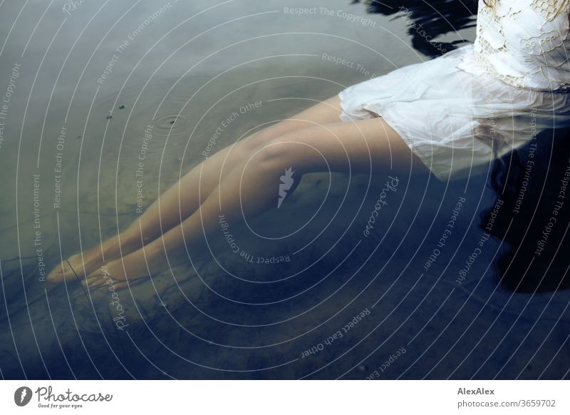 Close portrait of a young woman in a white dress sitting in a lake Purity Beautiful weather Close-up Feminine Day Colour photo Identity Exterior shot