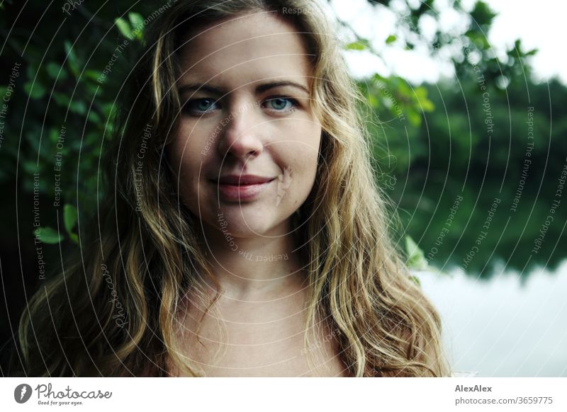 Close portrait of a young woman in front of a forest Curly White Purity luck Beautiful weather Trip Expectation Sunlight Joy Close-up Feminine Day