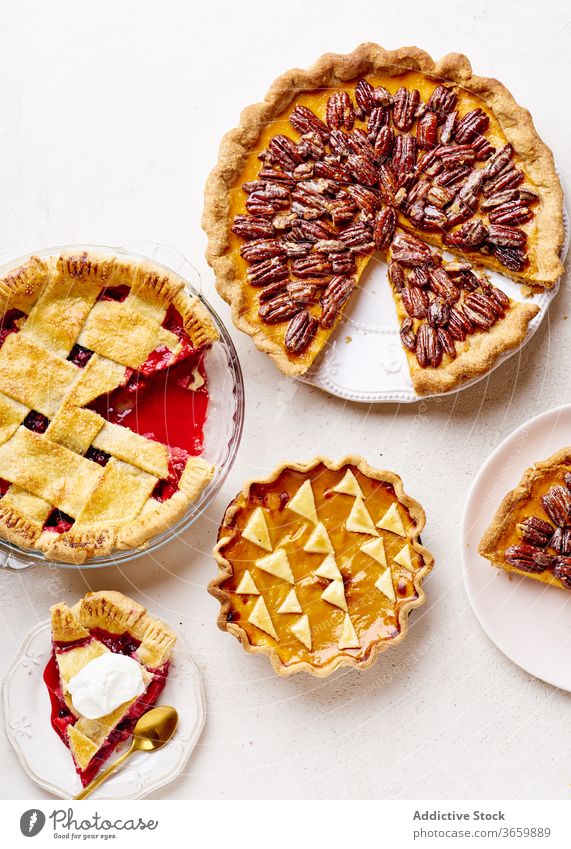 Top view shot of variety of thanksgiving pies food pecan apple pumpkin season autumn baking dinner seasonal round traditional closeup fresh cuisine table