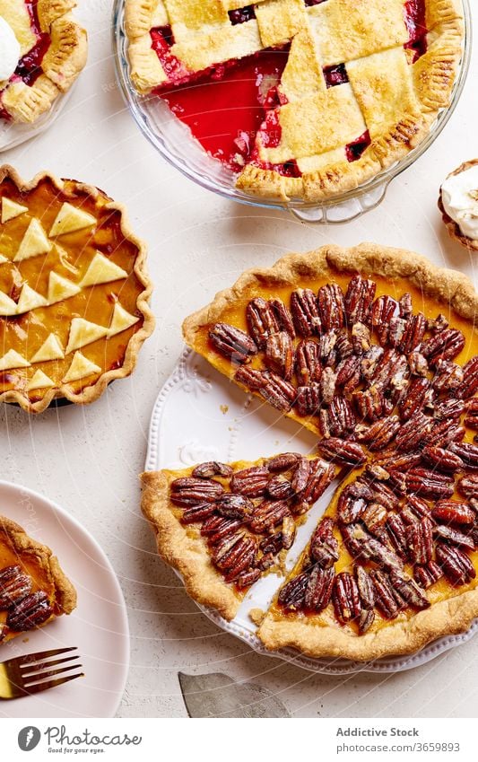 Top view shot of variety of thanksgiving pies food pecan apple pumpkin season autumn baking dinner seasonal round traditional closeup fresh cuisine table